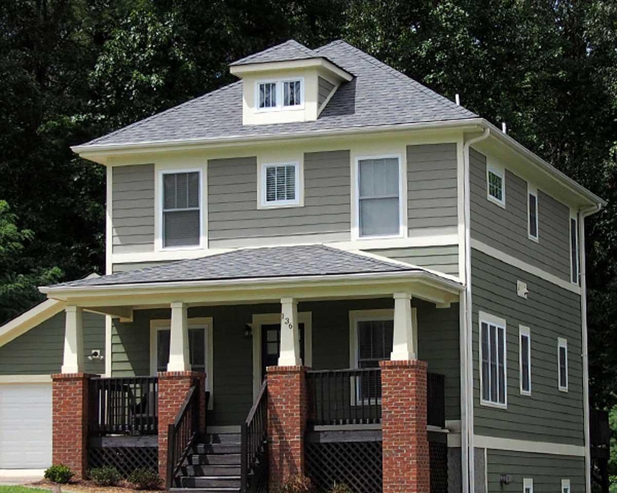 House plan exterior: Two-story home with a covered front porch, brick accents, multiple gables, and a dormer.