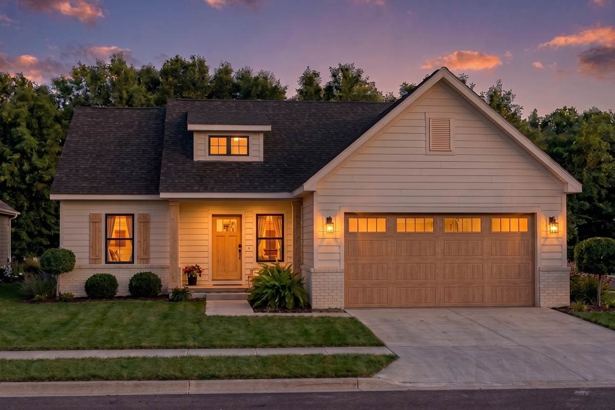 House plan exterior. One-story Modern Farmhouse with a front-facing garage, gabled roof, and a dormer above the entry.