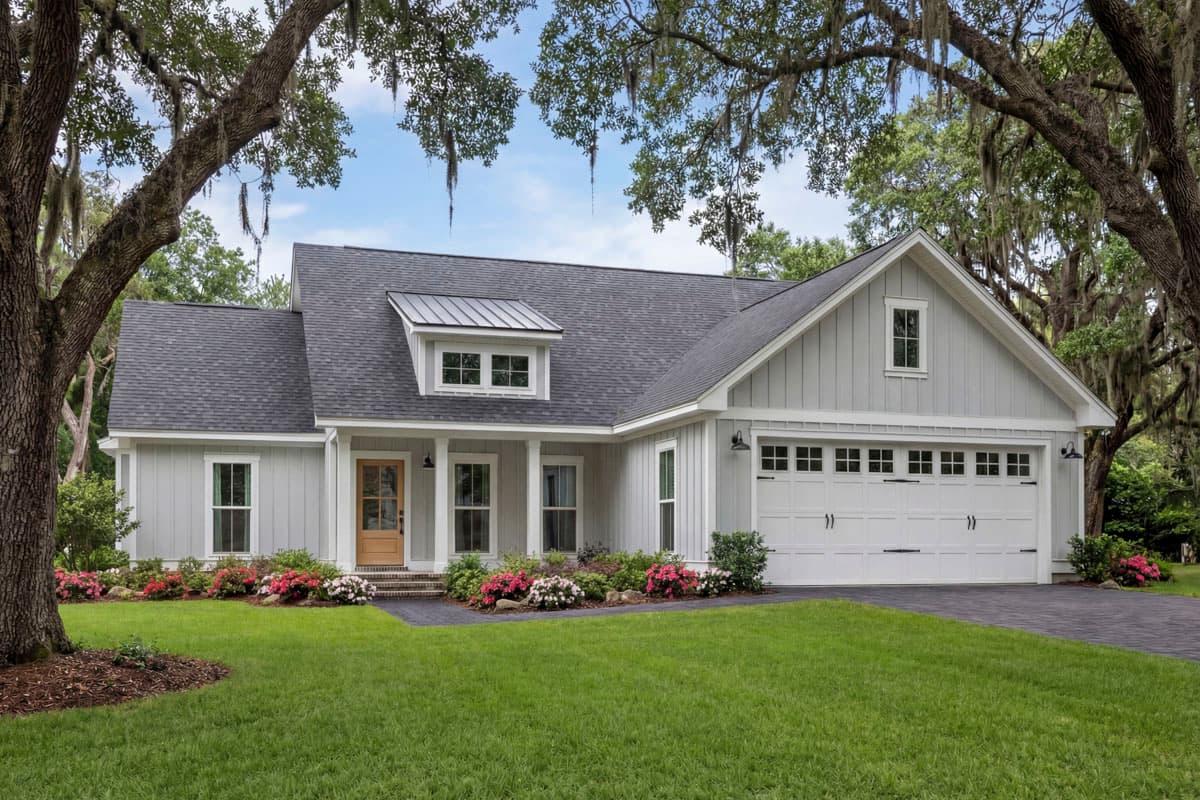 House plan exterior, modern farmhouse style, one story with board and batten siding, gable roof, dormer, and two-car garage.