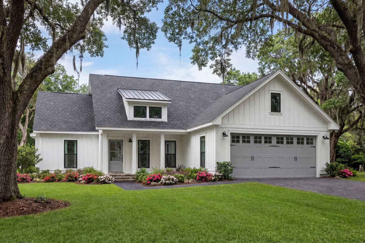 Modern Farmhouse house plan exterior with board and batten siding, dormer, and a three-car garage.