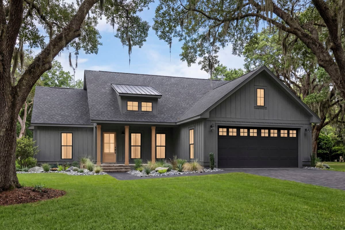 House plan exterior: Modern Farmhouse style, single story, with a prominent gable, dormer with metal roof, and attached two-car garage.