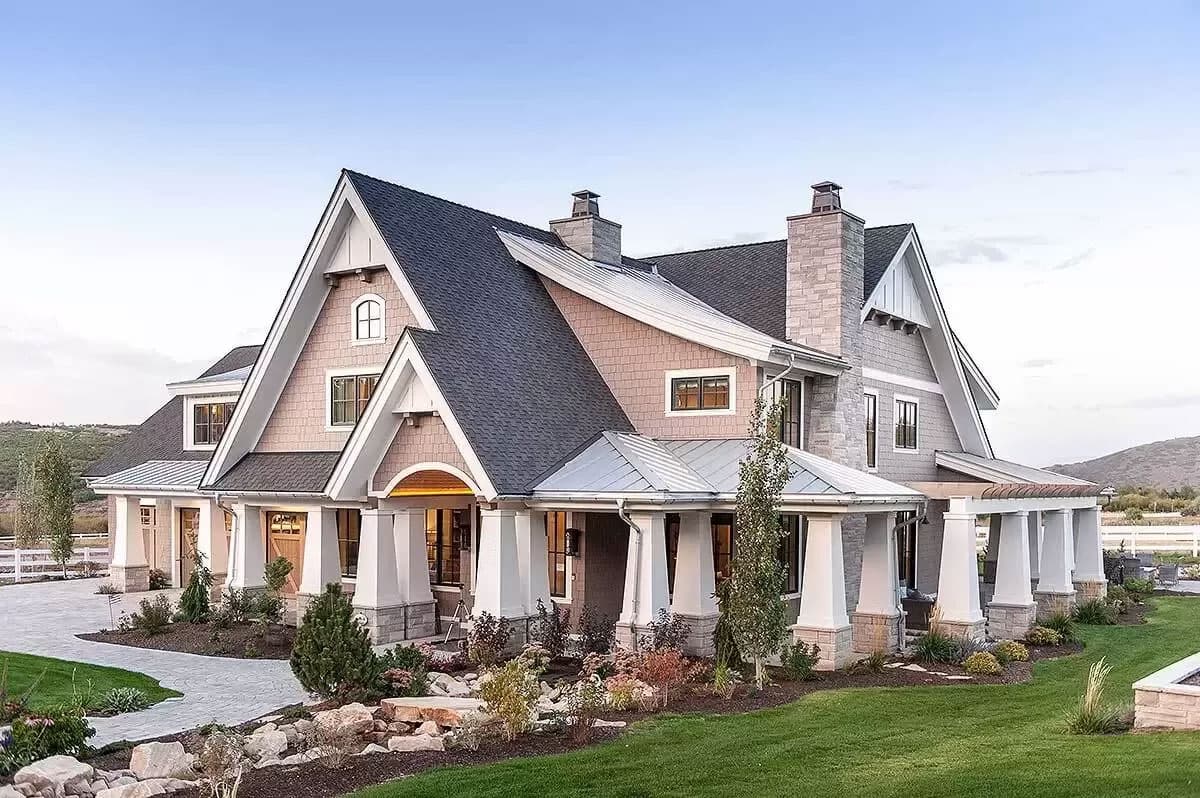 House plan exterior: Modern Farmhouse style with gables, dormers, stone chimneys, and a covered front porch supported by substantial columns.