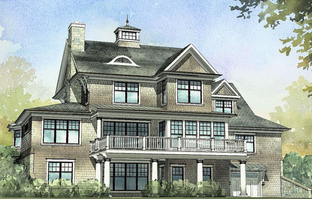 House plan exterior of a multi-story home with a prominent second-floor balcony, a cupola, and a stone chimney.