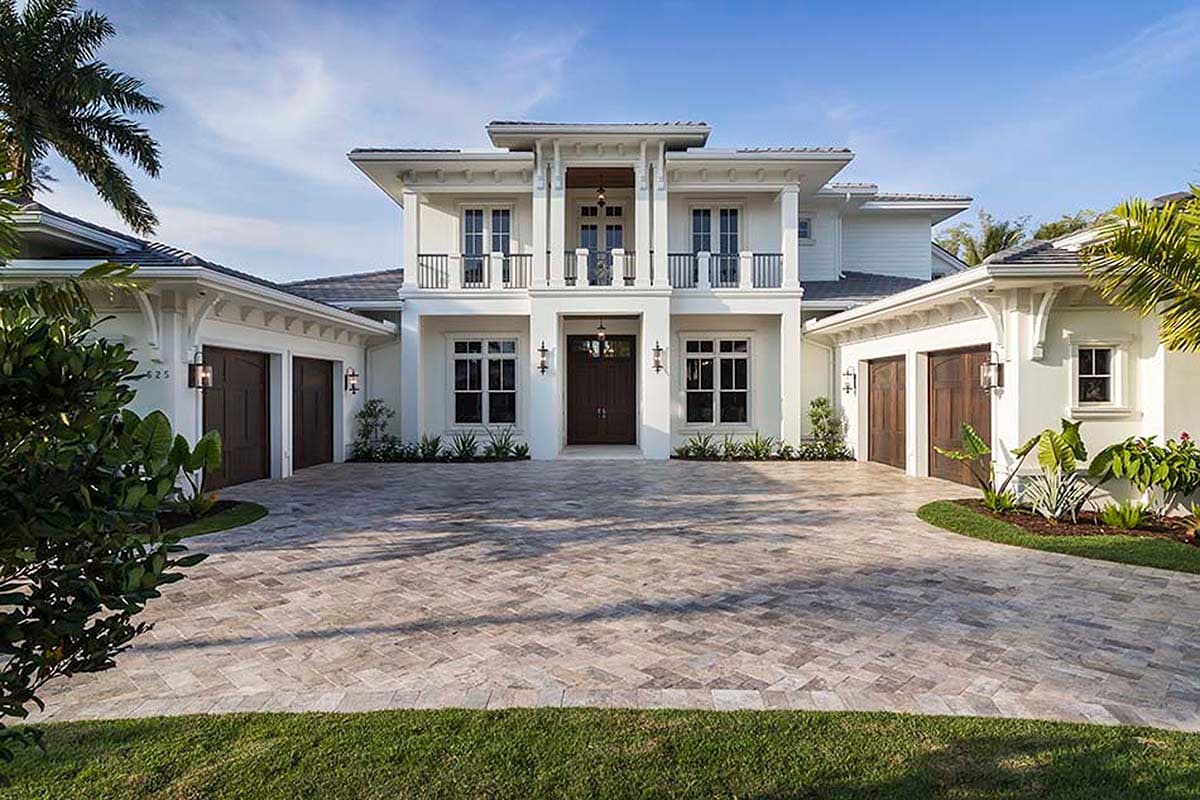 House plan exterior: two-story modern home with a covered entry, balconies, and a side-facing three-car garage.