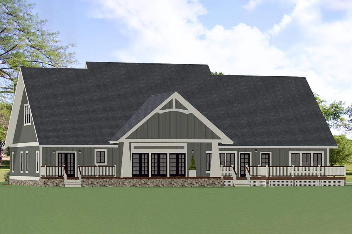 House plan exterior: Modern Farmhouse style, 1.5 stories, with a prominent gable, stone base, and wraparound deck.
