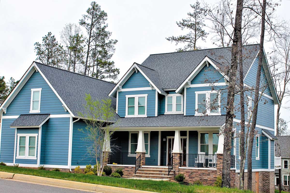 House plan exterior. Two-story, Craftsman-style home with a front porch, multiple gables, and a prominent roofline.