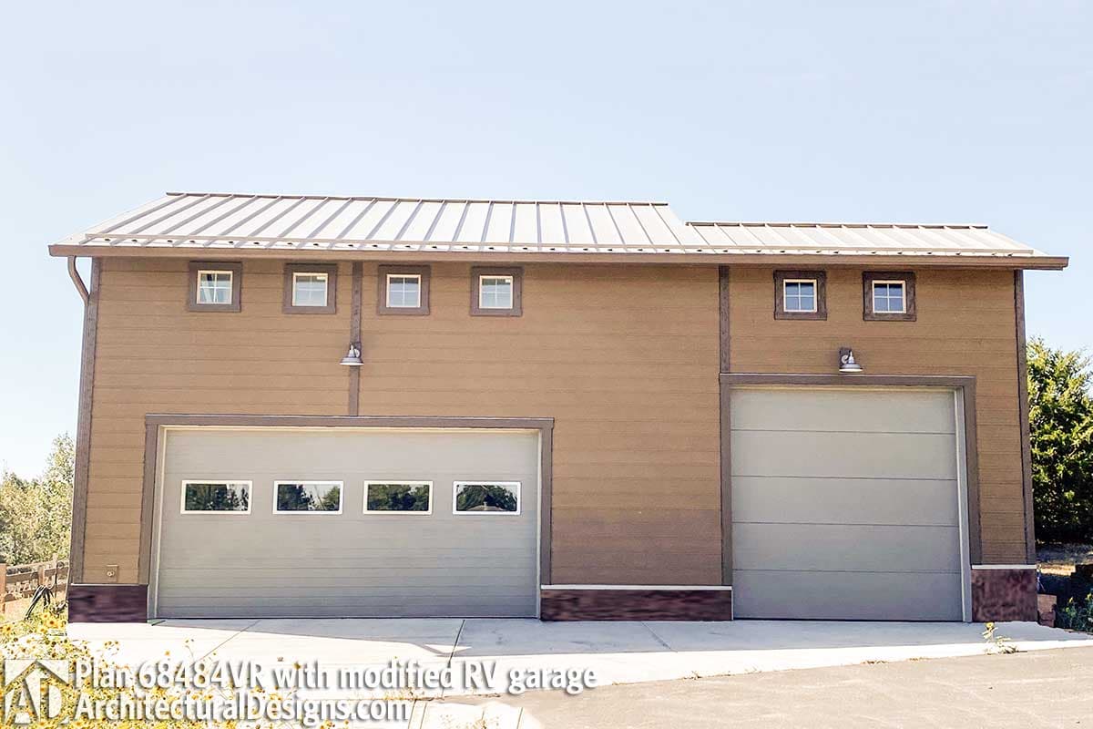 House plan exterior with brown siding, metal roof, and two garage bays, one oversized for RV.