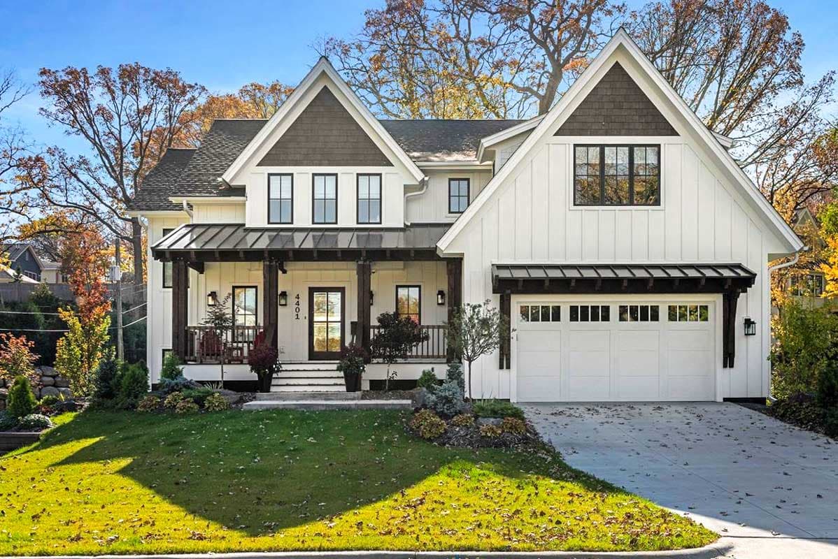 Modern Farmhouse house plan exterior with white board and batten siding, metal roof porch, gabled dormers, and attached garage.