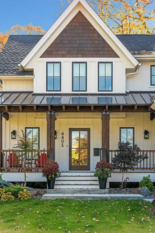Modern Farmhouse house plan exterior with covered porch, large gable with decorative shingles, and multi-pane windows.