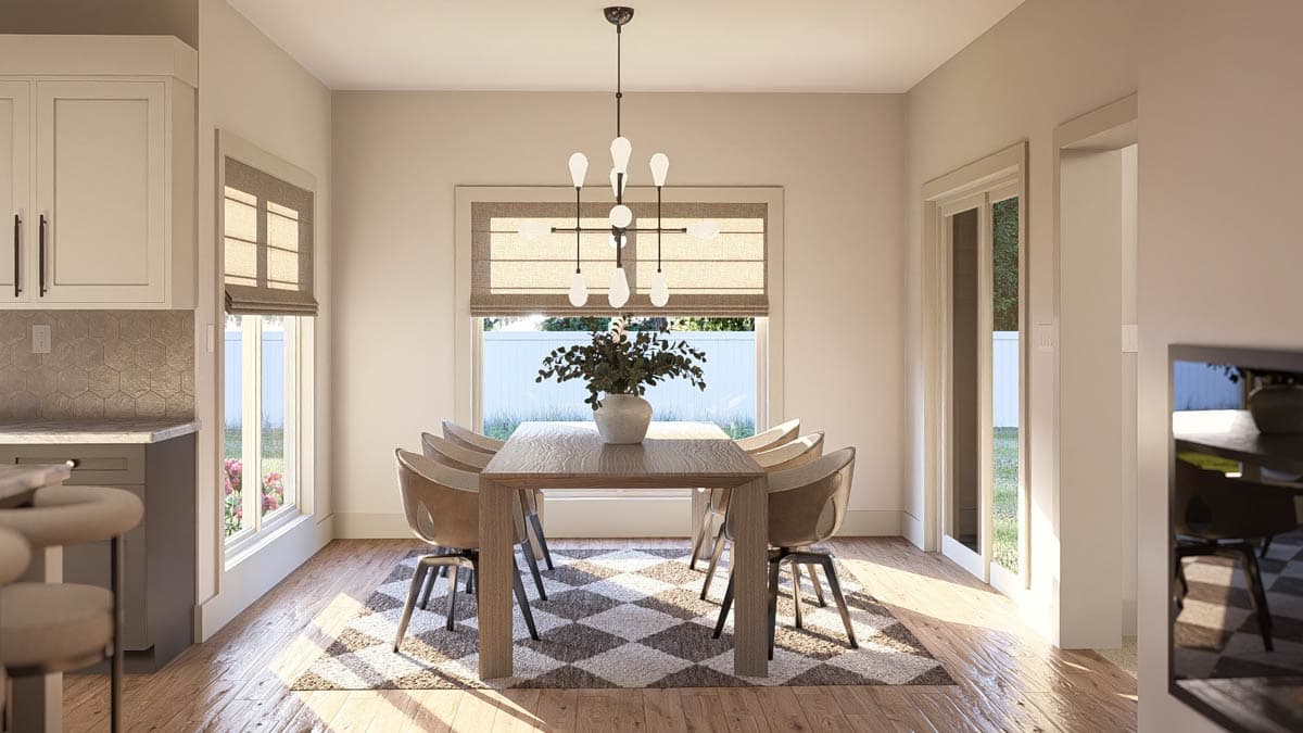 Dining area with wood table, chairs, pendant light, and large window with Roman shade overlooking backyard.