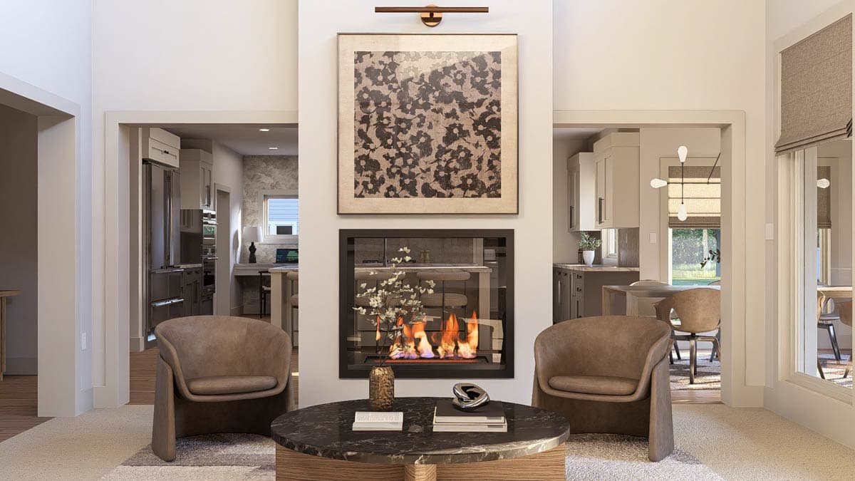 Living room with double-sided fireplace, view into kitchen with island, and dining area.