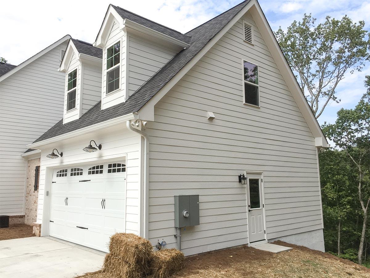 House plan exterior: Two-story Modern Farmhouse with a two-car garage, dormers, and gabled rooflines.
