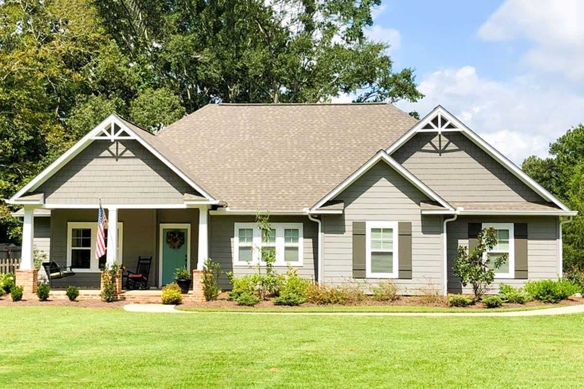 House plan exterior with Craftsman style, one story, front porch with columns, gables, and decorative roof brackets.