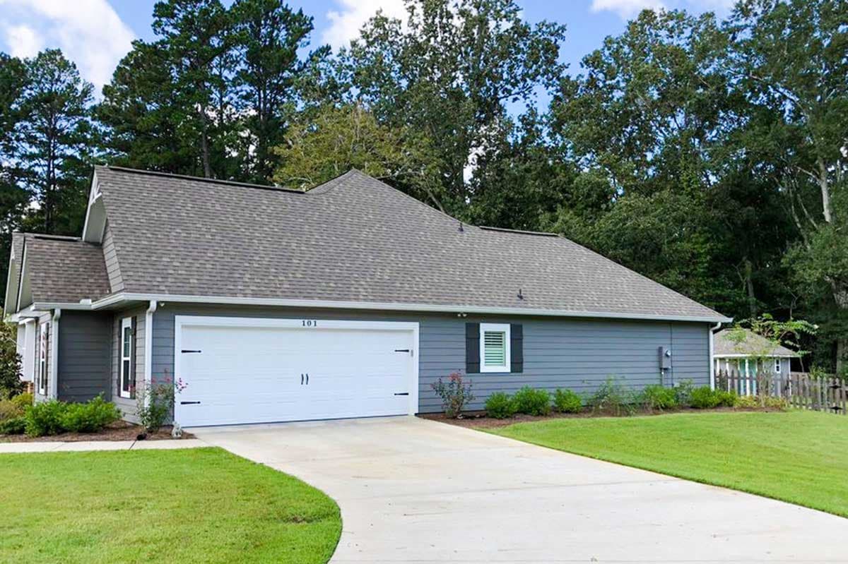 House plan exterior: One-story home with a side-facing garage, prominent gables, and horizontal siding.