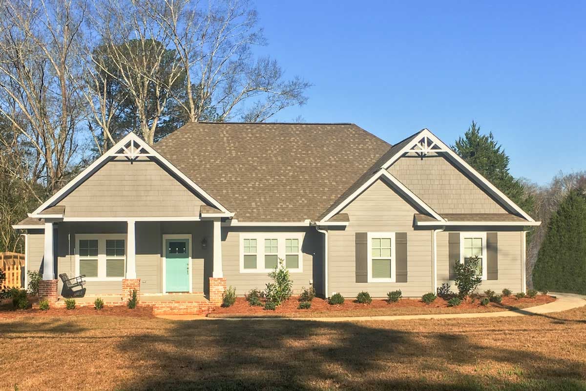 House plan exterior: One-story Ranch with gabled roof, front porch, dormers, and shingle siding.