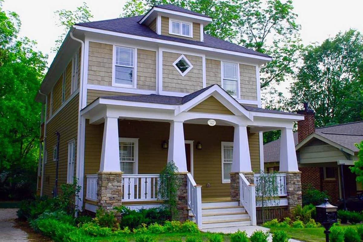 House plan exterior. Two-story Craftsman home with a front porch supported by columns. Features include gables, dormers, and a prominent roofline.