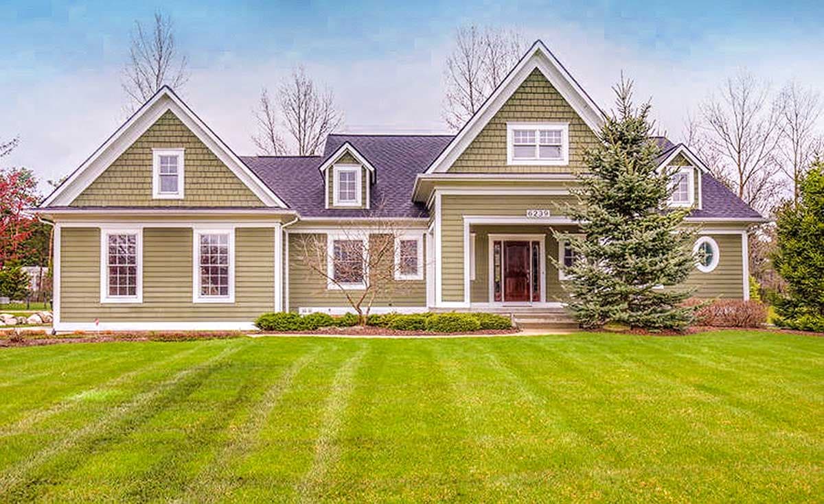 House plan exterior: Two-story home with gabled rooflines, dormers, shingle and lap siding, and a covered entry porch.
