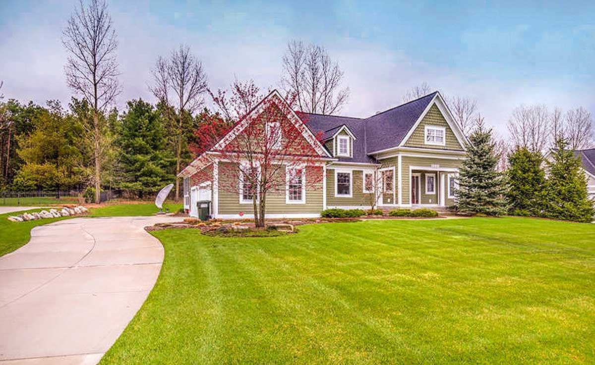 House plan exterior: One-and-a-half-story Modern Farmhouse with gabled dormers, a prominent front gable, and an attached garage.