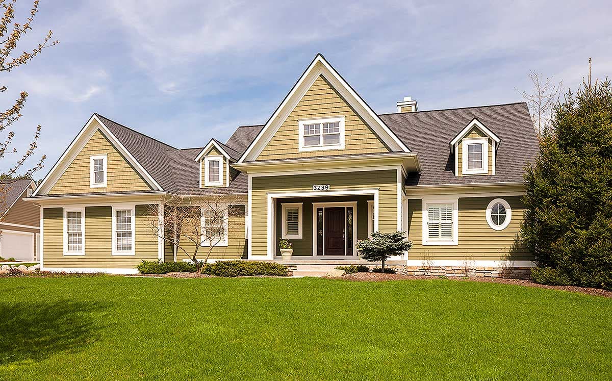 House plan exterior. Two-story Craftsman home with gabled roof, dormers, and a covered front porch with columns.