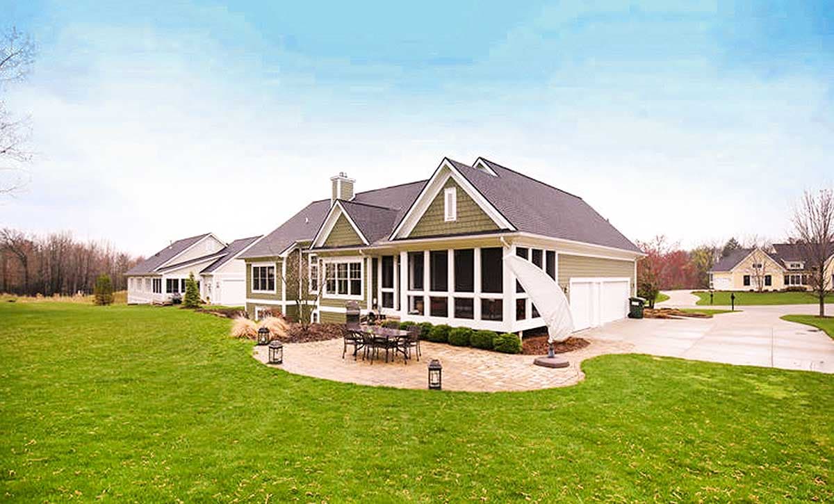 House plan exterior: Two-story home with a screened porch, gables, and a three-car garage.