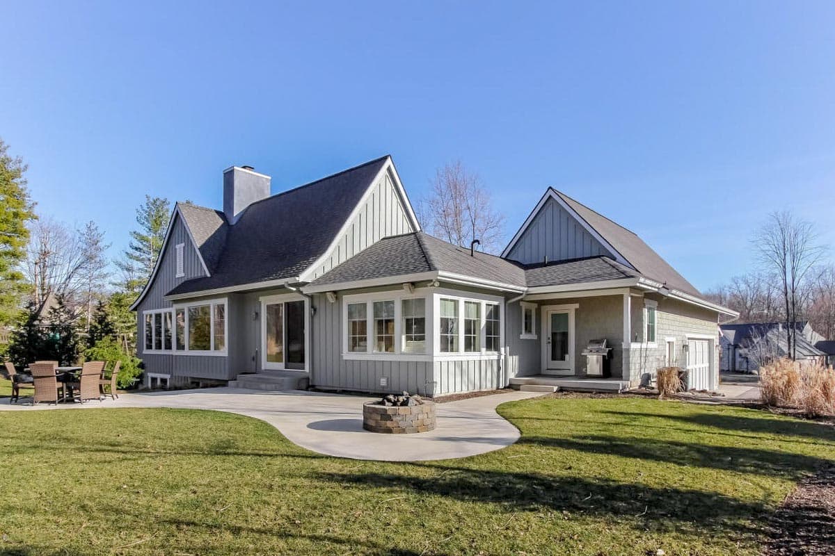 House plan exterior: Two-story Modern Farmhouse with gables, dormer window, multiple window styles, and attached garage.