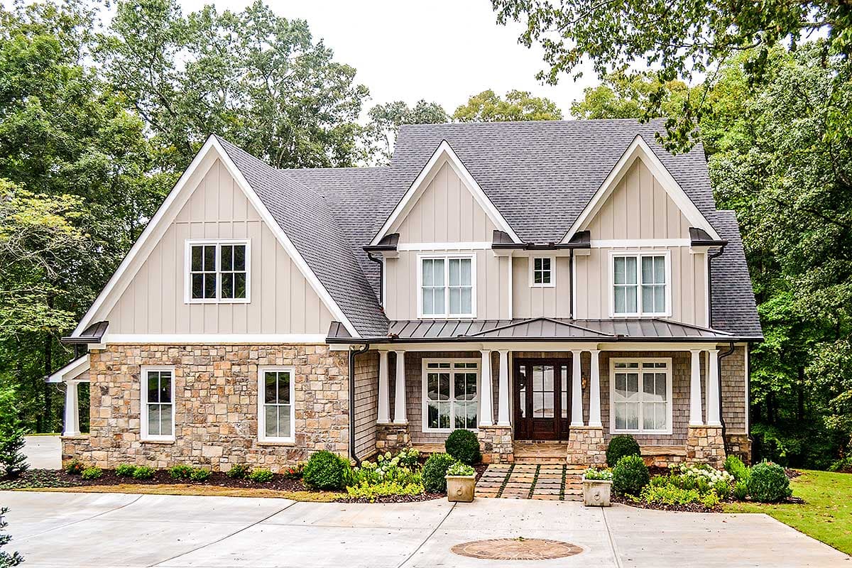 House plan exterior. Two-story Modern Farmhouse with stone facade, gabled roof, and covered front porch supported by columns.