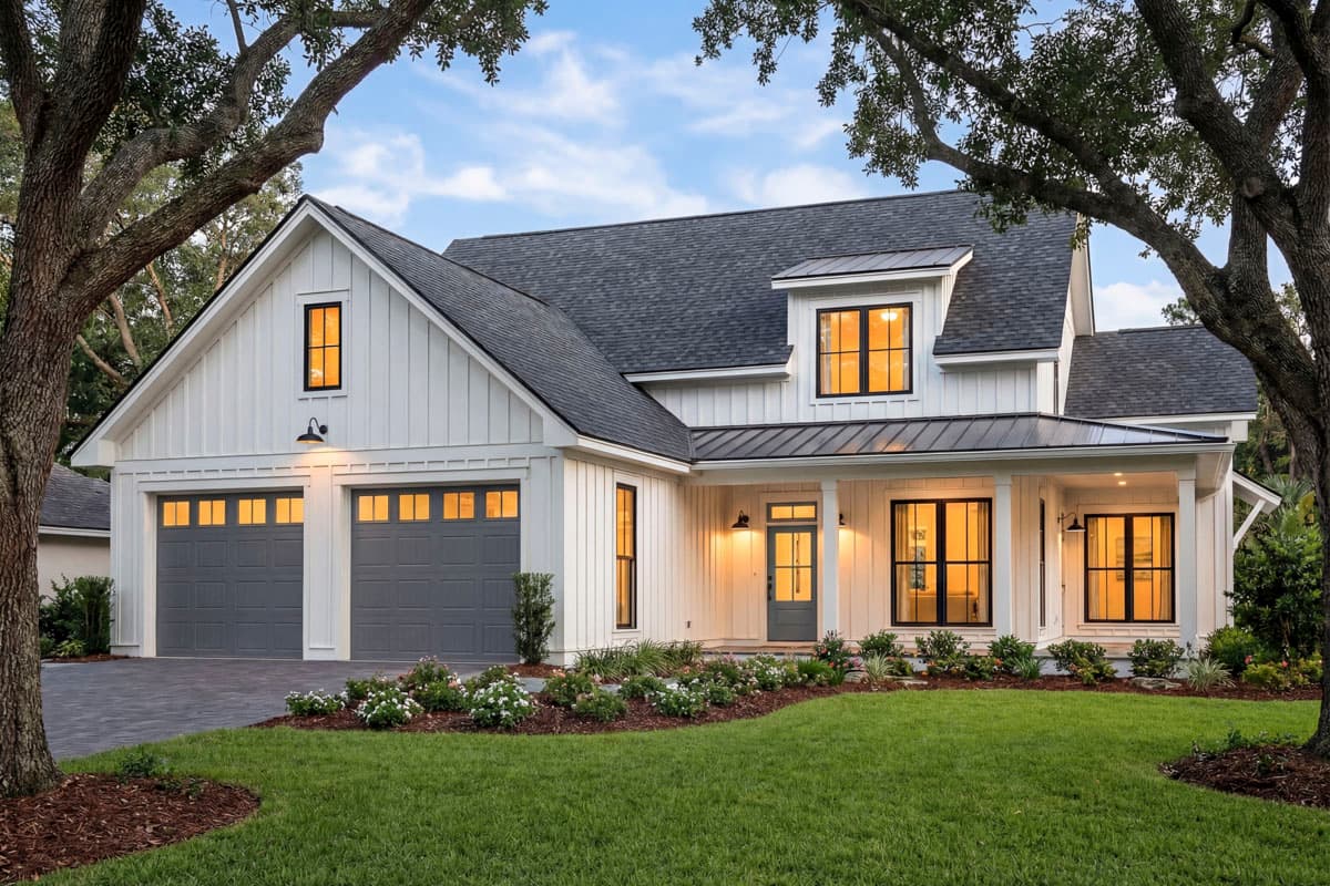 Modern Farmhouse house plan exterior with board and batten siding, a prominent gable, dormer, and a two-car garage.