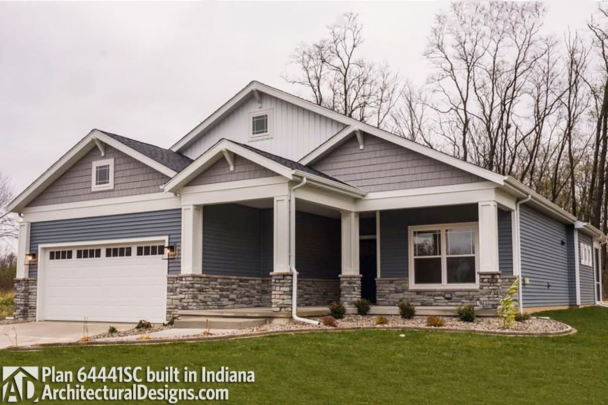 House plan exterior: Ranch style with a covered front porch, stone accents, and a two-car garage.