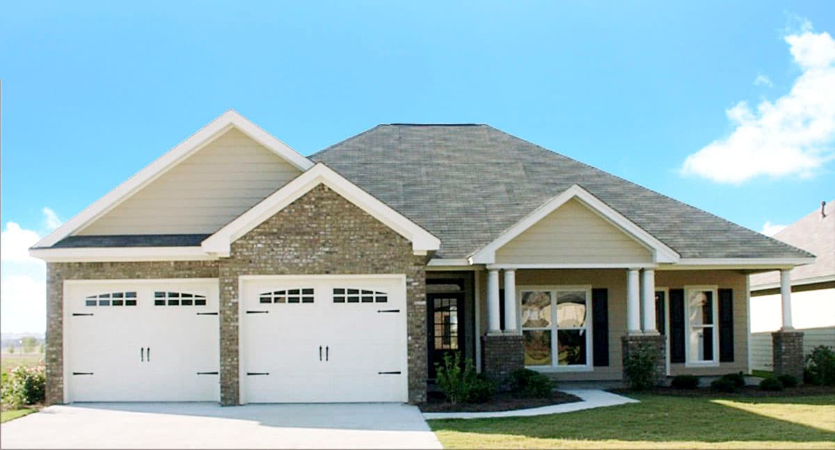 House plan exterior with two-car garage, brick facade, and front porch with columns. Features include gabled rooflines and dormers.