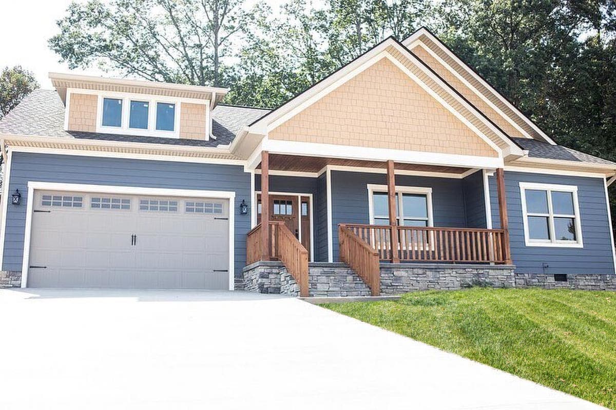 House plan exterior: Ranch style, front facing, with covered front porch, gabled dormer, and attached garage.
