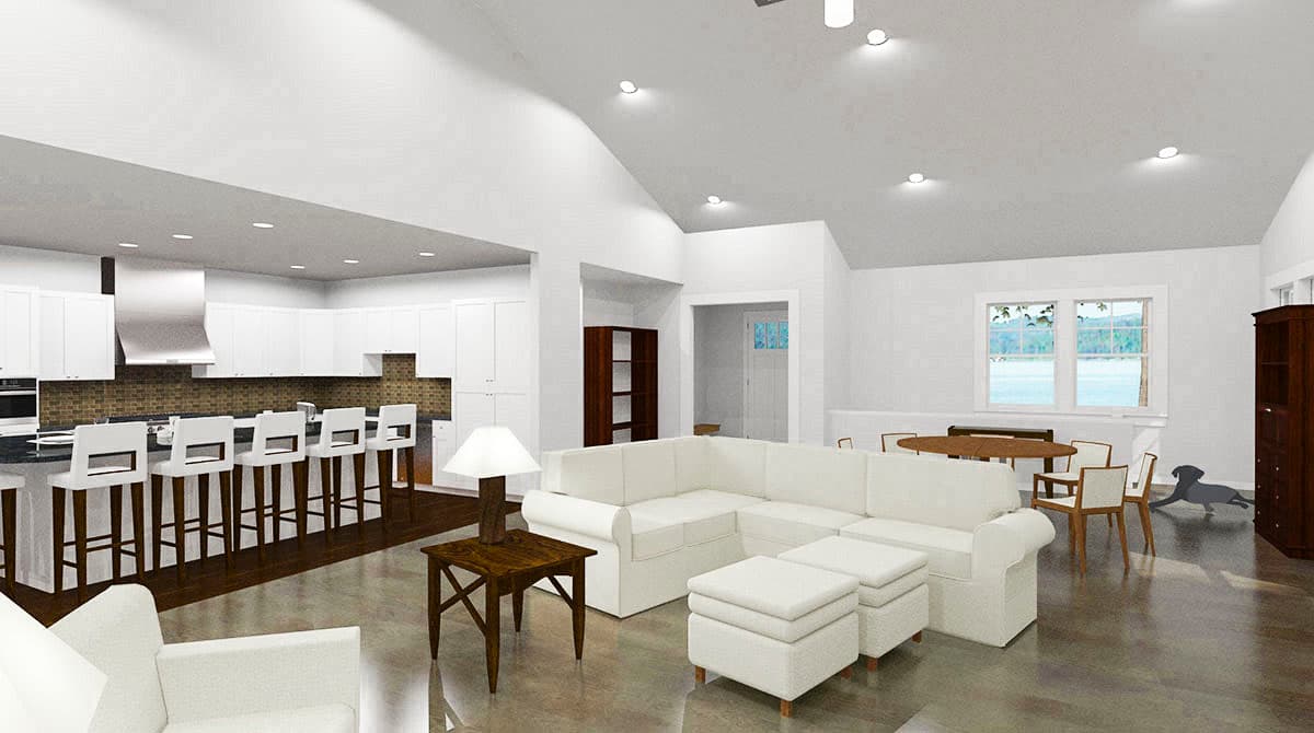 Open-concept living area with kitchen island, sectional sofa, dining table, and vaulted ceiling.