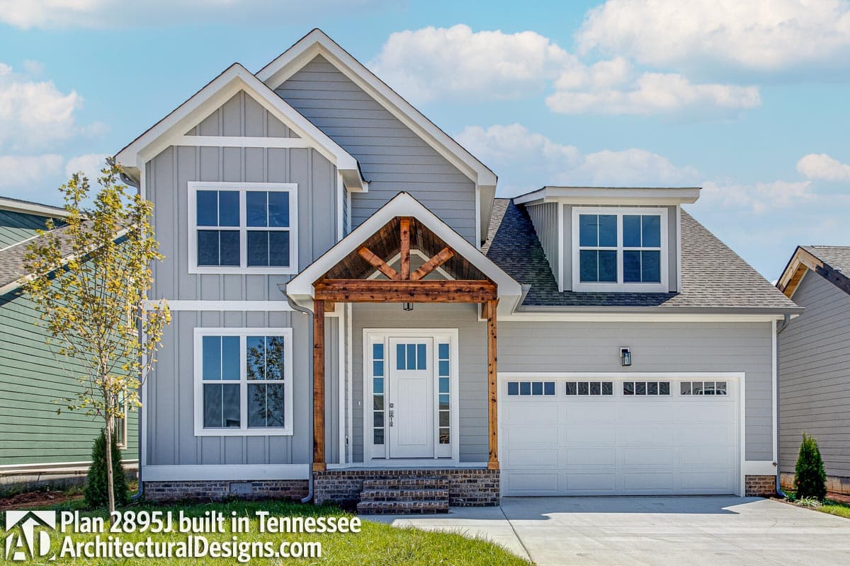Modern Farmhouse house plan exterior with prominent gables, decorative porch beams, dormer, and two-car garage.