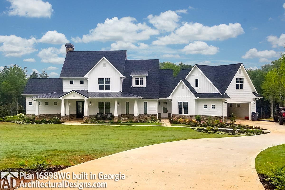 Modern Farmhouse house plan exterior with a wrap-around porch, multiple gables, and a detached garage.