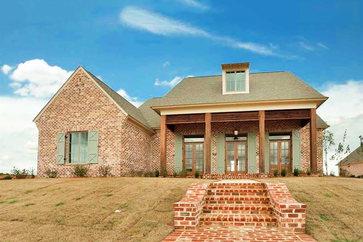 House plan exterior: brick, one-story, covered porch with wood columns, gable dormer.