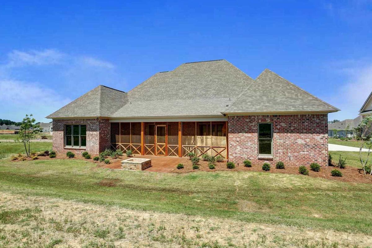 House plan exterior: Single-story brick home with a large screened-in porch, multiple gables, and a fire pit.