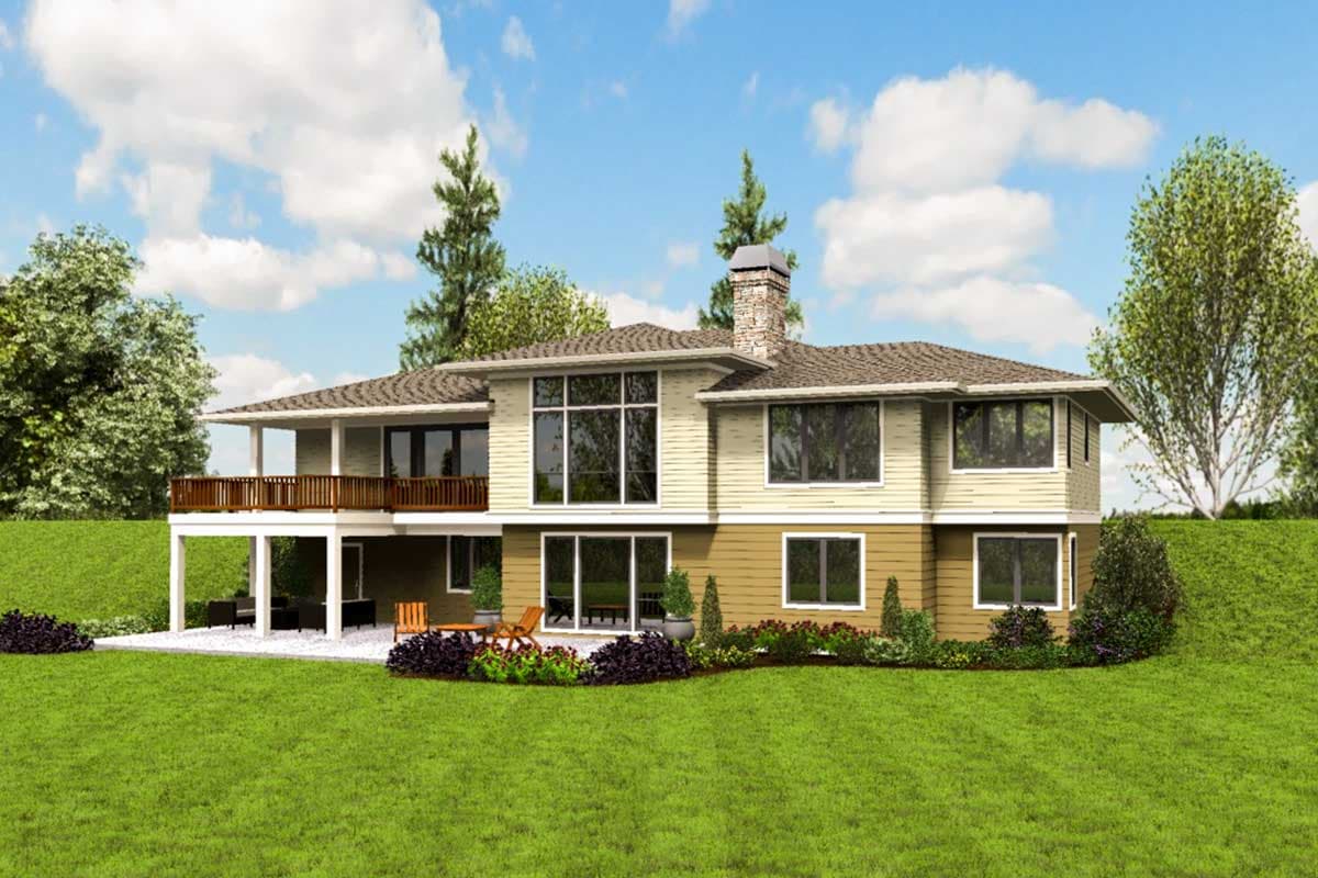 House plan exterior: Two-story home with wrap-around deck, large windows, and stone chimney.
