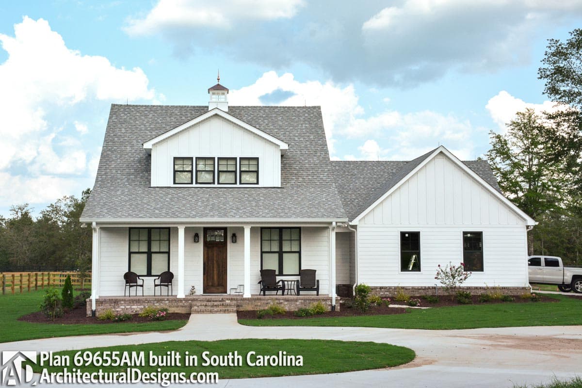 Modern Farmhouse house plan exterior with a covered front porch, white board-and-batten siding, gables, and dormers.