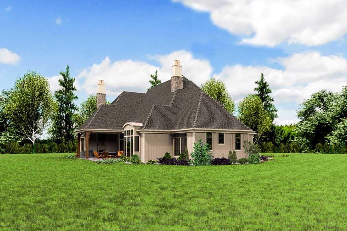 House plan exterior: Single-story home with steeply pitched rooflines, two stone chimneys, and a covered porch with outdoor seating.
