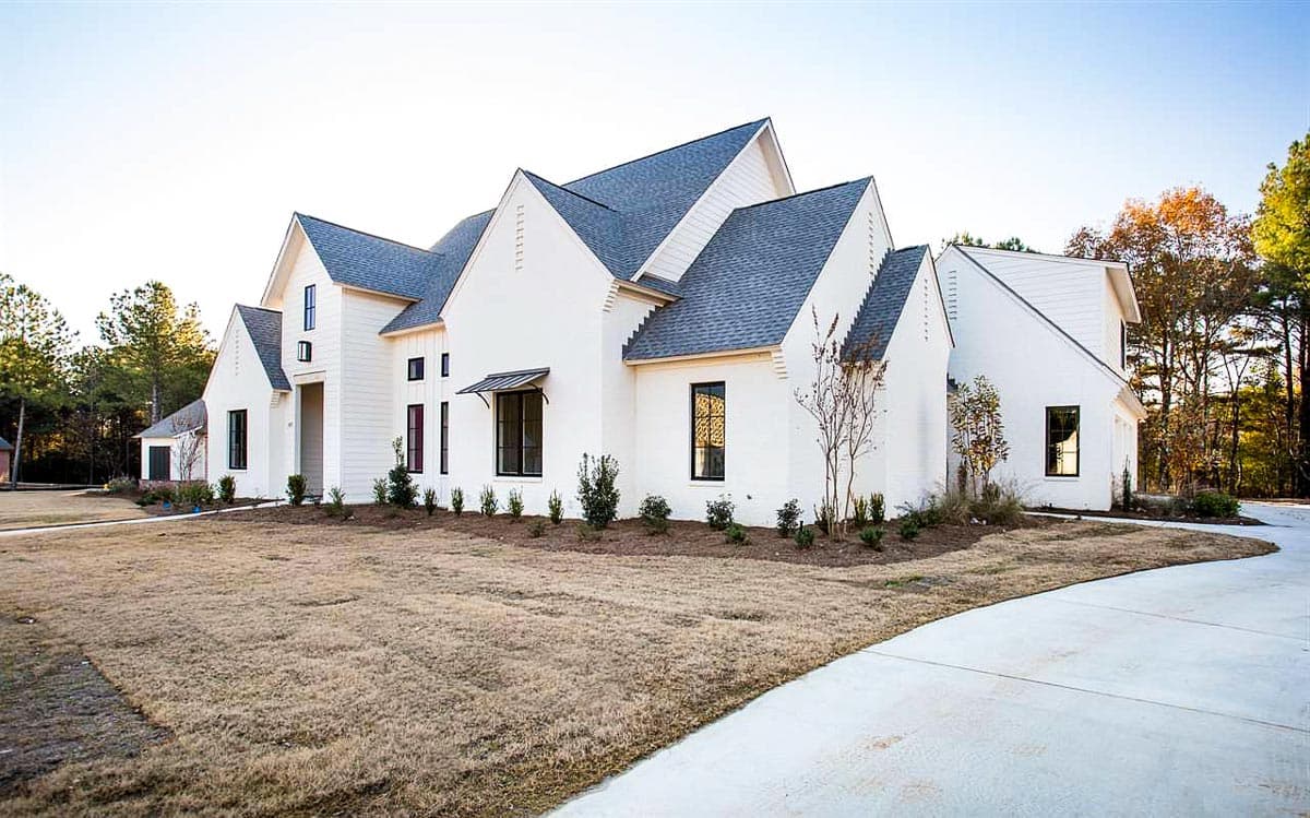 Modern Farmhouse exterior: white brick, multiple gables, board-and-batten siding accents, and dark-trimmed windows.