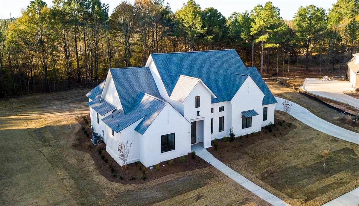 House plan exterior with modern farmhouse style, multiple gables, and large windows.