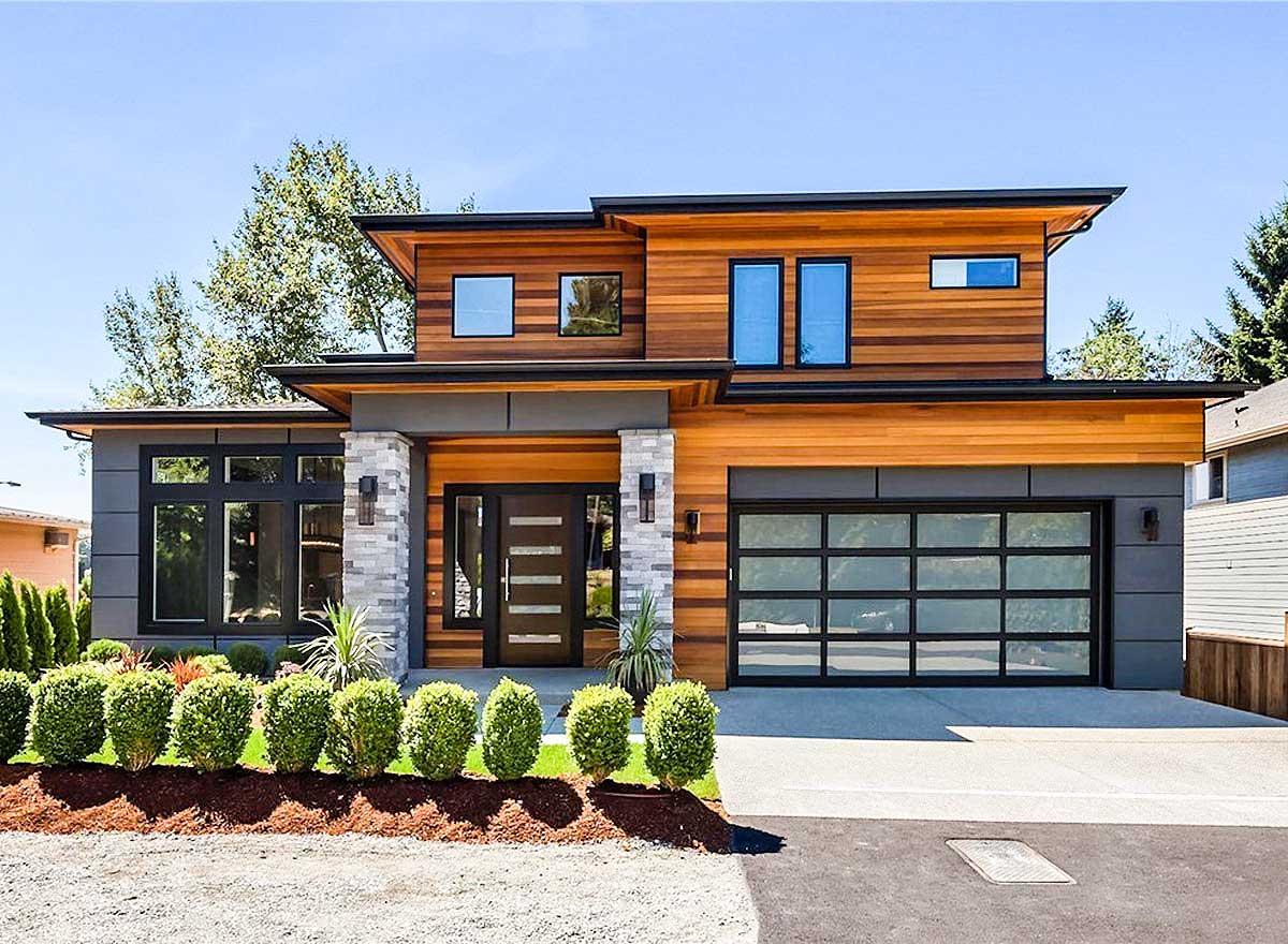 House plan exterior with modern design. Features wood siding, a glass garage door, and a flat roofline. Two-story home with large windows.