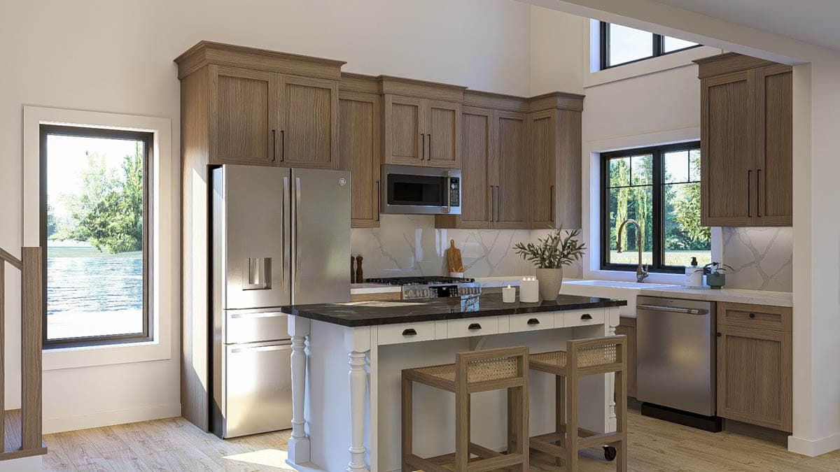 Kitchen with wood cabinetry, island seating, stainless steel appliances, and large windows overlooking greenery.