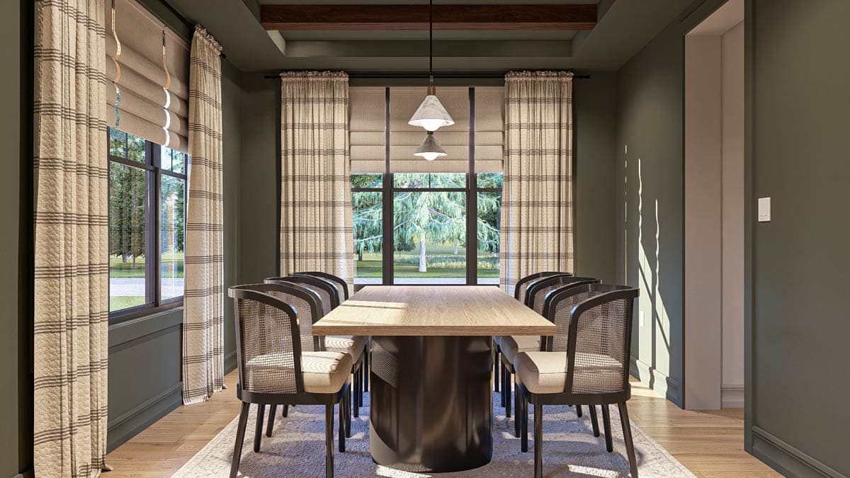 Dining room with large window, wooden table, cane-backed chairs, and coffered ceiling with wooden beams.