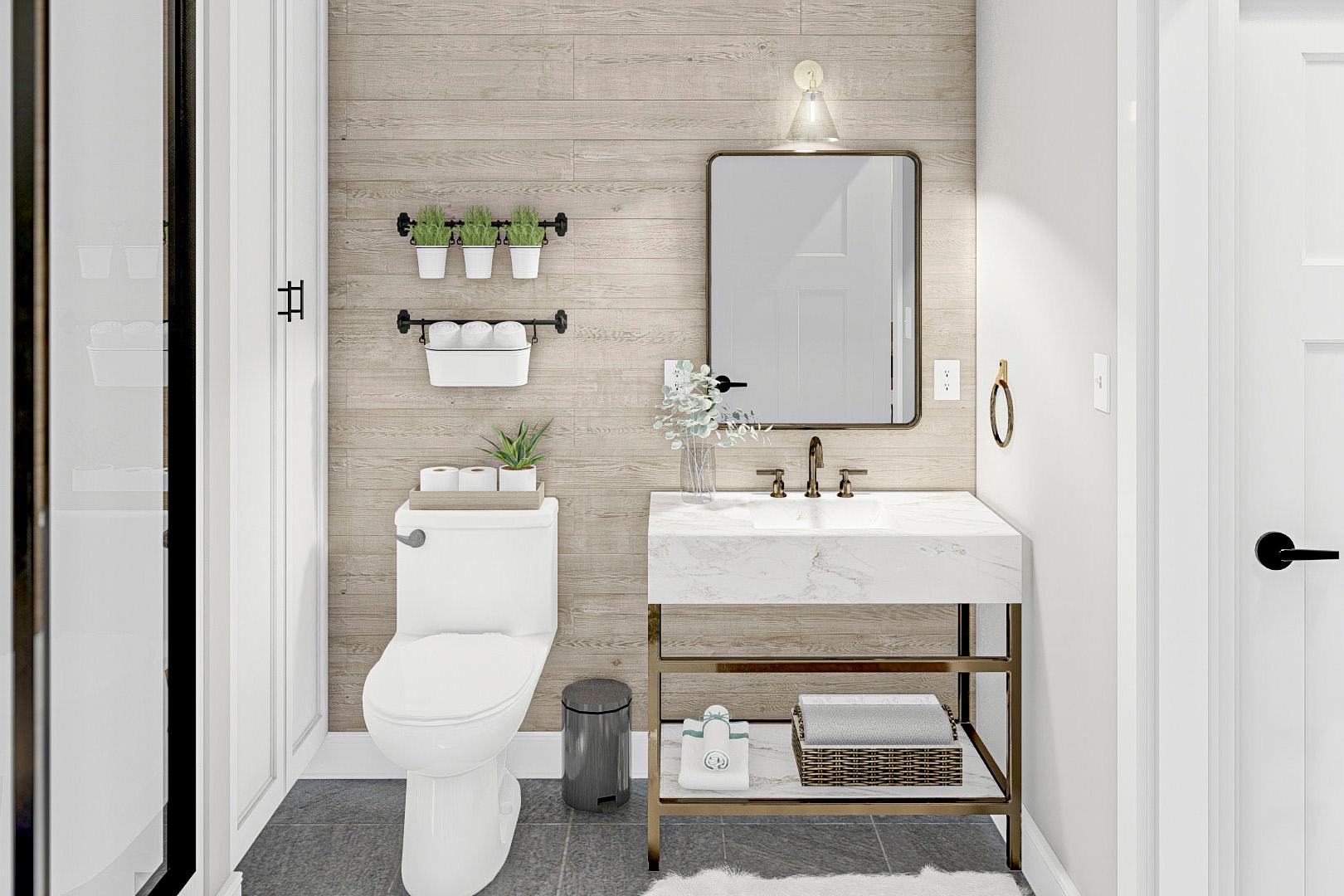 Bathroom with marble vanity, toilet, shower enclosure, and wood plank accent wall.