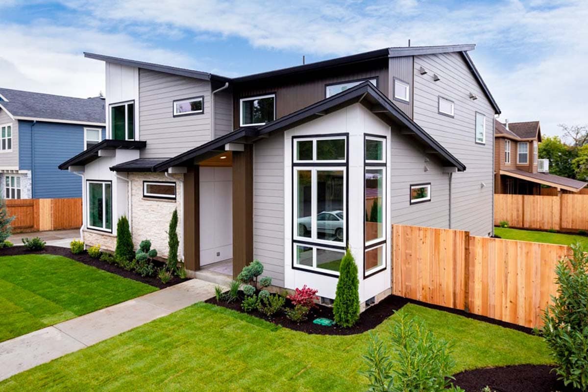 Modern house plan exterior featuring a multi-story design, varied rooflines, and prominent bay window.