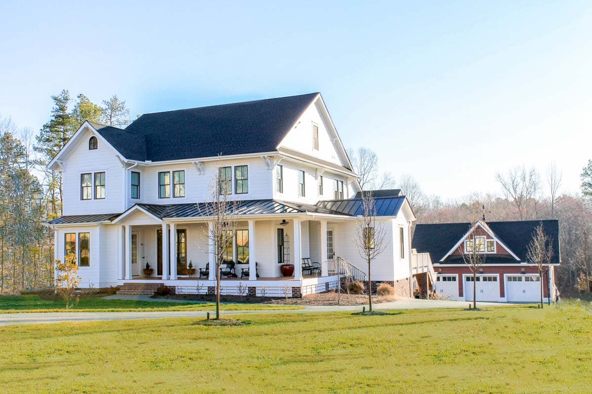 Modern Farmhouse house plan exterior with wrap-around porch, multiple gables, and attached three-car garage.