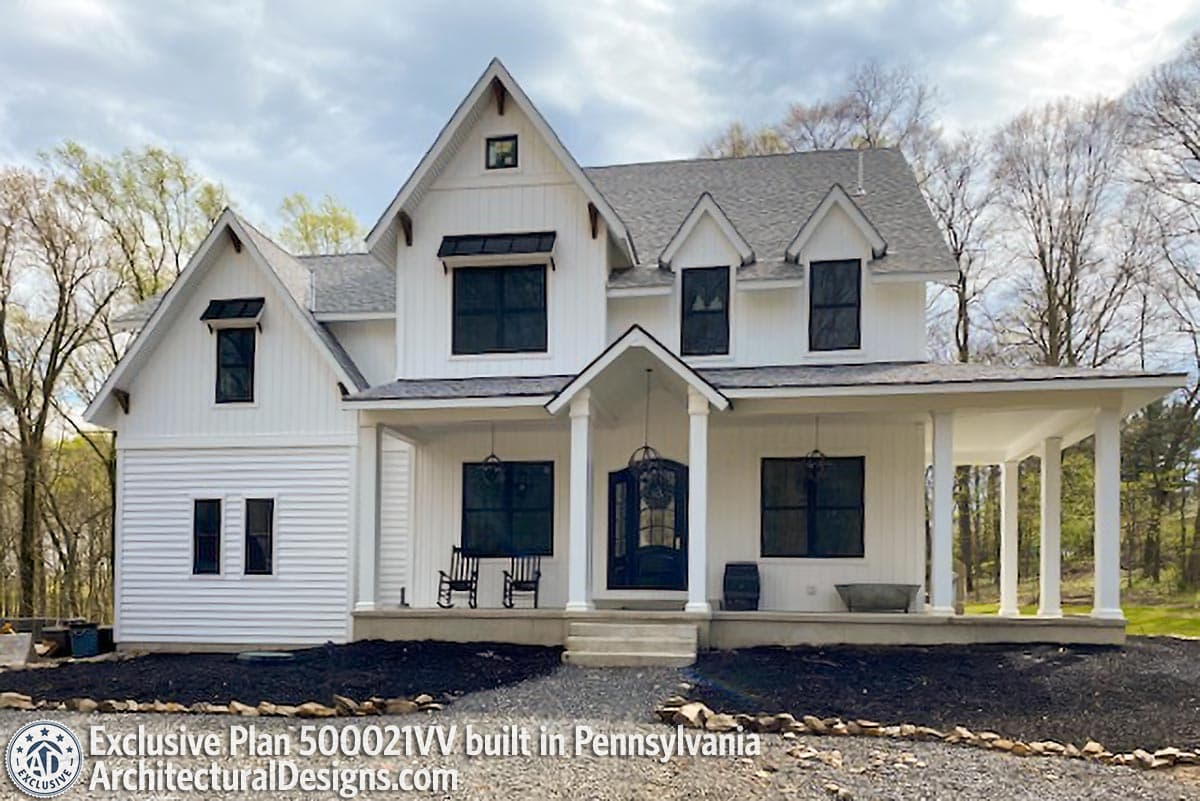 House plan exterior: Modern Farmhouse style, two stories, white siding, gables, dormers, wrap-around porch, dark-framed windows.