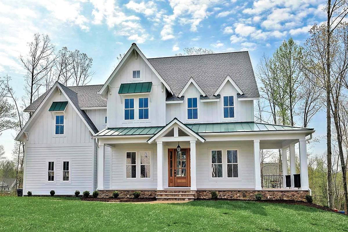 House plan exterior. Two-story Modern Farmhouse with gabled roof, front porch, and dormers. Features include green awnings and stone foundation.