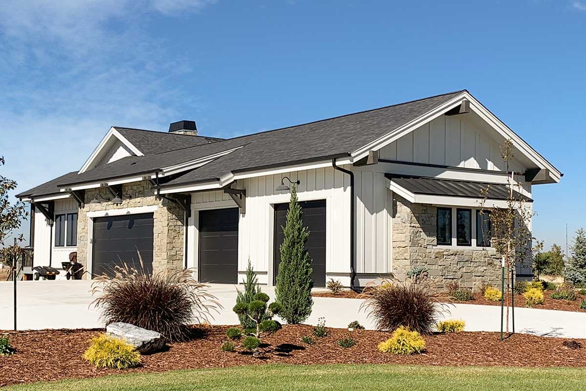 Modern ranch house plan exterior with stone and board-and-batten siding, a three-car garage, and prominent gables.