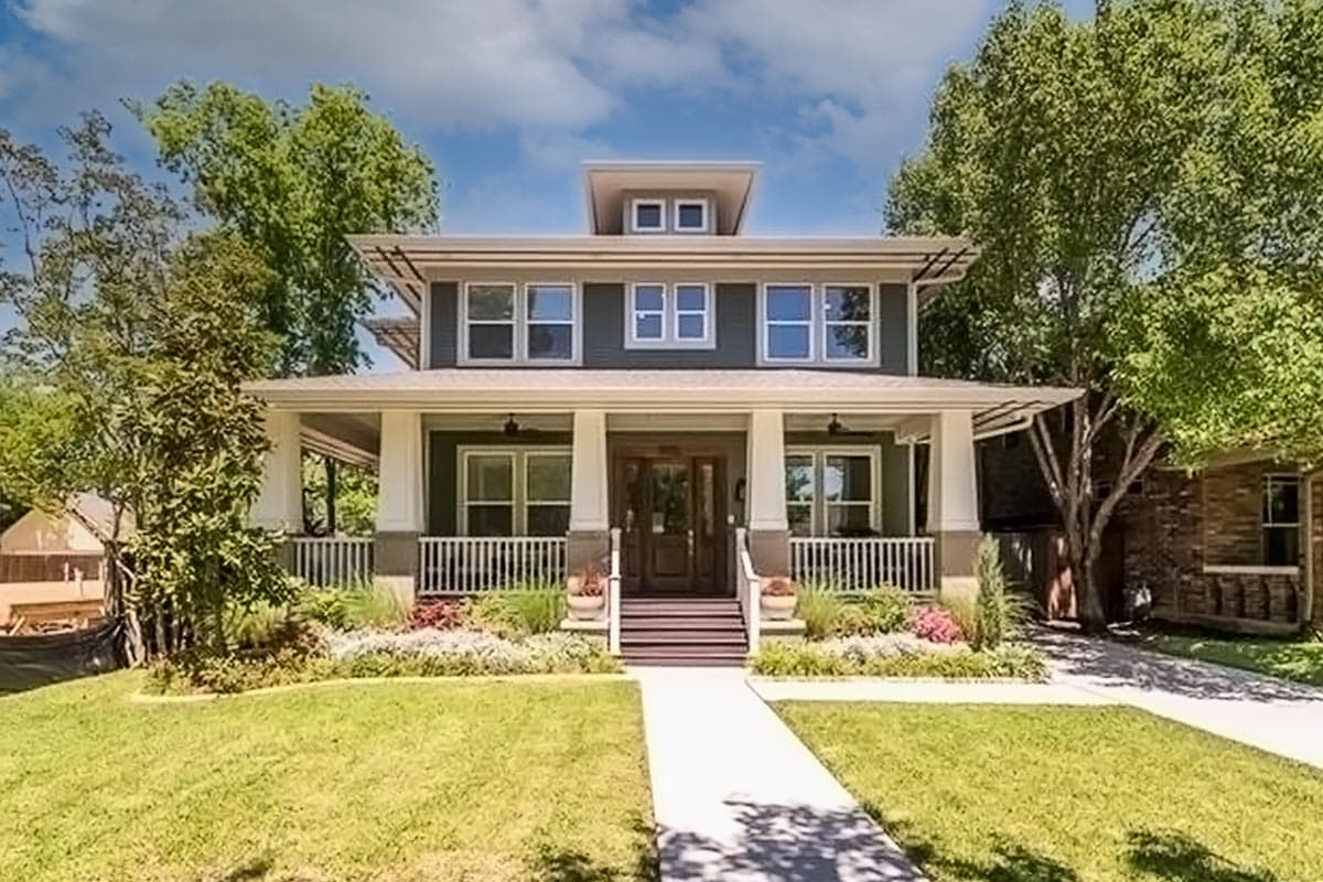 House plan exterior: Two-story Craftsman home with a large front porch, prominent gables, and a flat roof with a cupola feature.